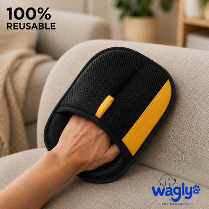 A hand wearing the 100% reusable Wagly glove, grooming a fabric sofa