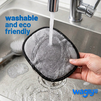 The Wagly glove being rinsed clean under a running kitchen tap — washable and reusable