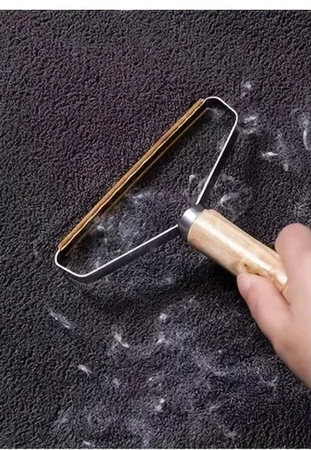 Dark carpet covered in pet hair before using the scraper